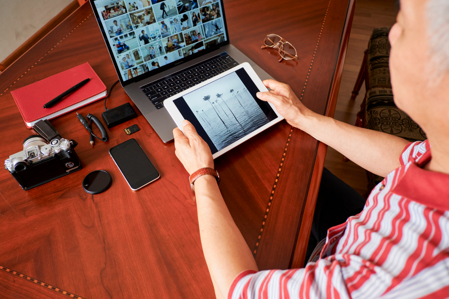 a man with a tablet and a laptop